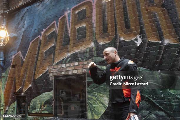 Jack Miller of Australia and Ducati Lenovo Team poses near murals along Duckboard Place to ACDC Lane during the 2022 MotoGP of Australia Preview...