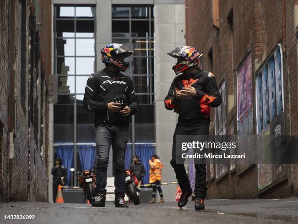 Jack Miller of Australia and Ducati Lenovo Team and Remy Gartner of Australia and Tech3 KTM Factory Racing walk along Duckboard Place to ACDC Lane...