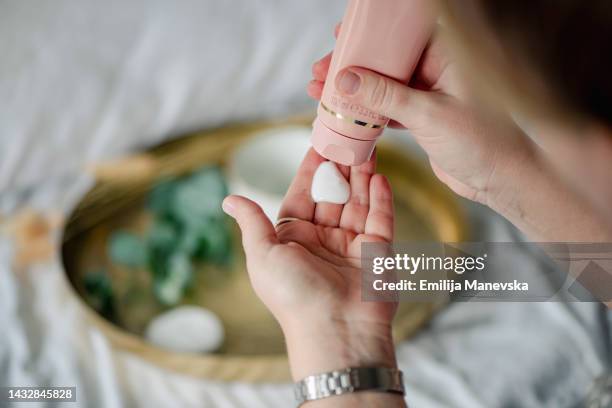 close up of woman applying hand cream - handkräm bildbanksfoton och bilder