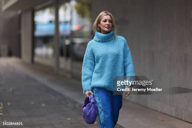 Tanja Comba is seen wearing blue oversize turtleneck knit wool sweater from Christian Wijnants, blue velvet Balenciaga wide leg pants and a purple...