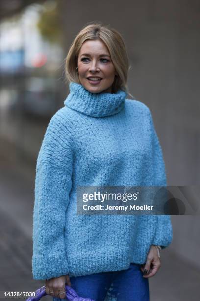 Tanja Comba is seen wearing blue oversize turtleneck knit wool sweater from Christian Wijnants, blue velvet Balenciaga wide leg pants, on October 08,...