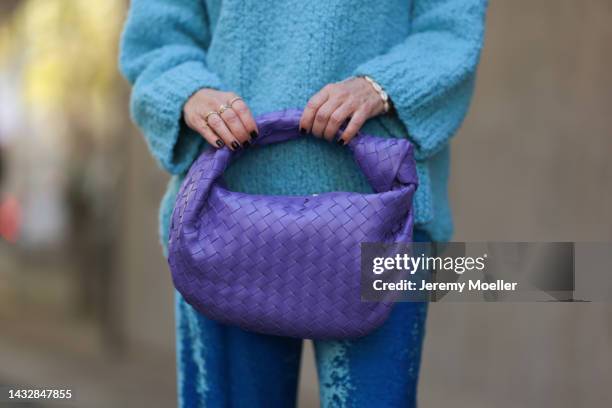 Tanja Comba is seen wearing blue oversize turtleneck knit wool sweater from Christian Wijnants, blue velvet Balenciaga wide leg pants and a purple...