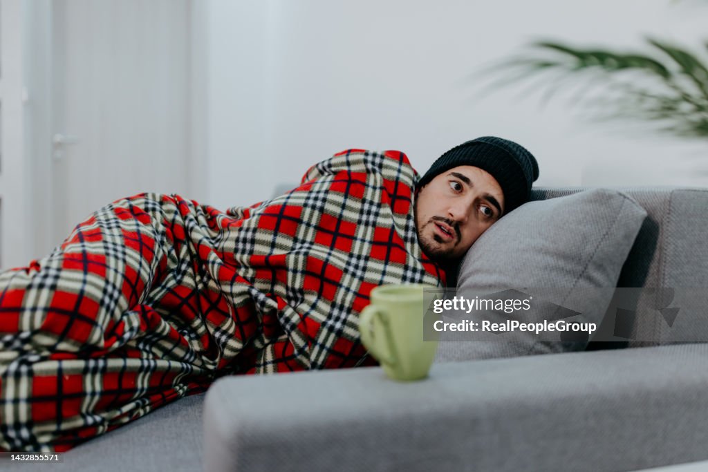 Man all alone suffering from a cold