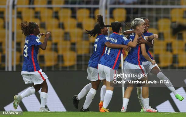 Lucie Calba of France is congratulated on scoring her teams first goal during the Group D match between Canada and France during the FIFA U-17...