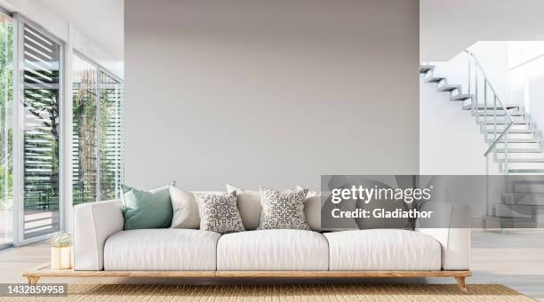 cozy, luxury, and modern living room with sofa, windows and decoration - a close up on the sofa - cozy home interior stock pictures, royalty-free photos & images