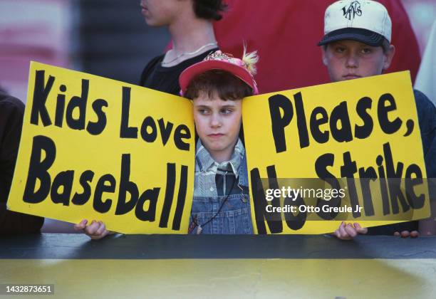 General view of young baseball fans holding up signs protesting against the proposed strike by the Major League Baseball Players Association during...