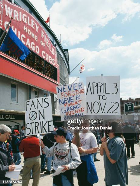 General view of baseball fans of the Chicago Cubs holding up signs protesting against the 1994 season strike by the Major League Baseball Players...