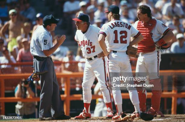 Buck Rodgers, Team Manager for the California Angels argues a call by Umpire Dale Scott as Angels pitcher Mark Langston and Catcher Lance Parrish...