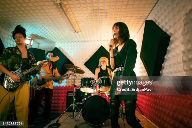 urban band having rehearsal at the music recording studio - rock group stock pictures, royalty-free photos & images