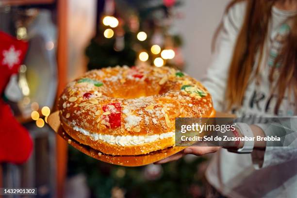 close-up of roscón de reyes with the christmas lights behind - roscon de reyes stock pictures, royalty-free photos & images