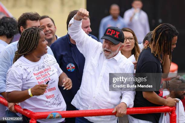 Presidential candidate Luiz Inácio Lula Da Silva of Worker's Party acknowledges supporters during a visit to Complexo do Alemao shanty town on...