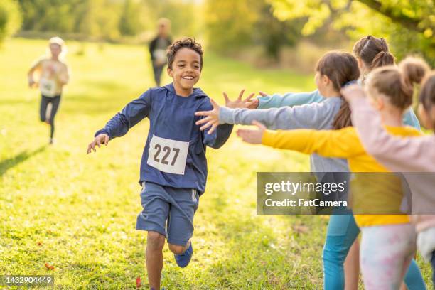 finishing a race with support - sports race stock pictures, royalty-free photos & images