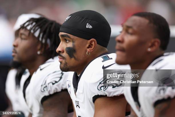 Quarterback Jalen Hurts of the Philadelphia Eagles watches from the bench during the NFL game at State Farm Stadium on October 09, 2022 in Glendale,...