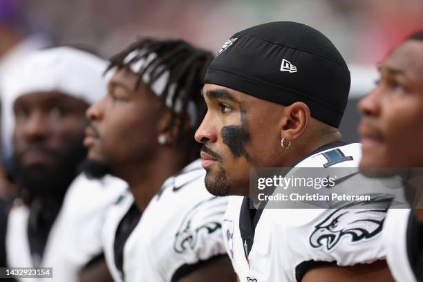 Quarterback Jalen Hurts of the Philadelphia Eagles watches from the bench during the NFL game at State Farm Stadium on October 09, 2022 in Glendale,...