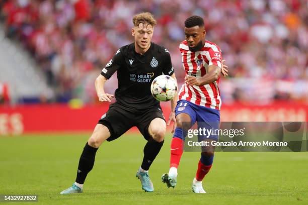 Thomas Lemar of Atletico Madrid is challenged by Andreas Skov Olsen of Club Brugge during the UEFA Champions League group B match between Atletico...