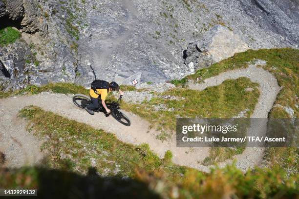 elevated view of mountain biker on tight curve on a trail - crans montana stock-fotos und bilder