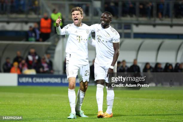 Thomas Muller of Bayern Munich celebrates with teammate Sadio Mane after scoring their team's second goal during the UEFA Champions League group C...