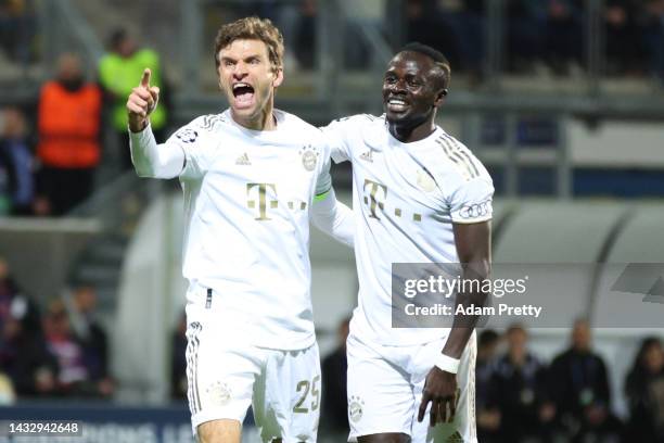 Thomas Muller of Bayern Munich celebrates with teammate Sadio Mane after scoring their team's second goal during the UEFA Champions League group C...