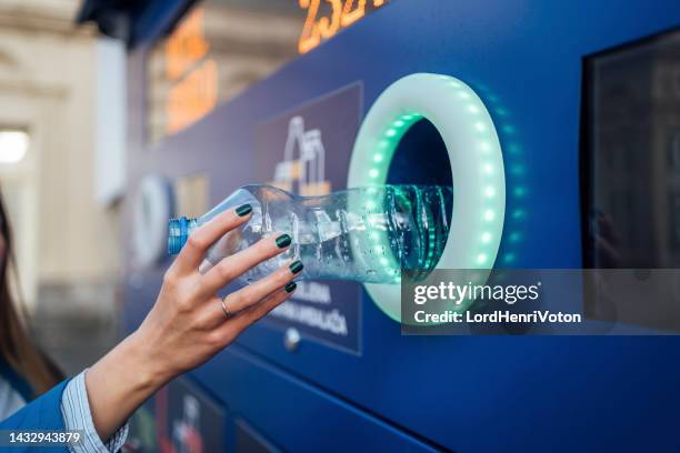 woman hand recycling plastic bottles - removing stock pictures, royalty-free photos & images