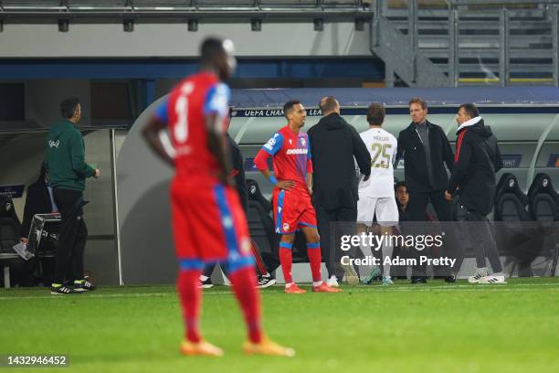 Thomas Muller of Bayern Munich interacts with Julian Nagelsmann, Head Coach of Bayern Munich after being substituted off during the UEFA Champions...