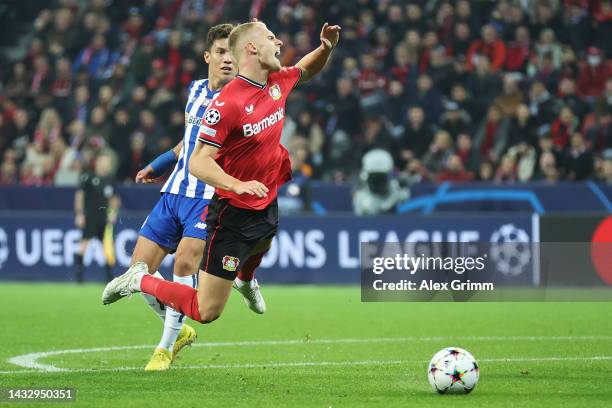 Mitchel Bakker of Bayer Leverkusen is tackled by Mateus Uribe of FC Porto which resulted in a penalty during the UEFA Champions League group B match...