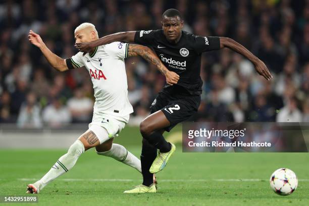 Richarlison of Tottenham Hotspur is challenged by Evan Ndicka of Eintracht Frankfurt during the UEFA Champions League group D match between Tottenham...