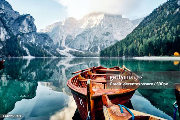 scenic view of lake by mountains against sky,pragser wildsee,italy - bergsee stock-fotos und bilder