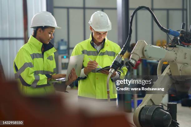 industrial engineer teams setting work function robotic arm systems - installing software stock pictures, royalty-free photos & images