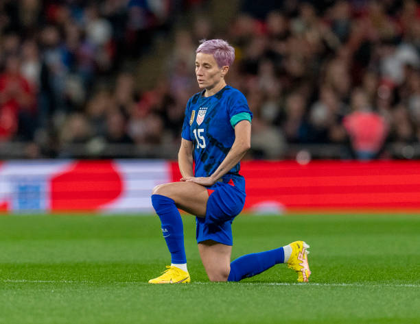 Megan Rapinoe of the United States kneels during a game between England and USWNT at Wembley Stadium on October 7, 2022 in London, England.