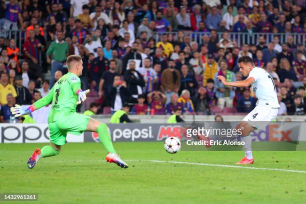 Kristjan Asllani of FC Internazionale has a shot saved by Marc-Andre ter Stegen of FC Barcelona during the UEFA Champions League group C match...