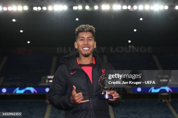 Roberto Firmino of Liverpool poses with the PlayStation Player of the match award following the UEFA Champions League group A match between Rangers...