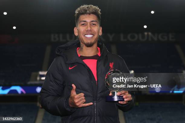 Roberto Firmino of Liverpool poses with the PlayStation Player of the match award following the UEFA Champions League group A match between Rangers...