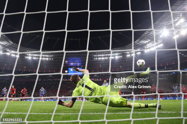 Mehdi Taremi of FC Porto scores their team's second goal from the penalty spot past Lukas Hradecky of Bayer Leverkusen during the UEFA Champions...
