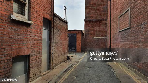 narrow back alley with industrial brick walls in london, england - old london city stock pictures, royalty-free photos & images