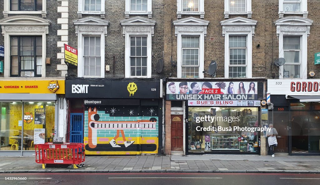 Store fronts along Kingsland High Street in Dalston, Hackney. London, England