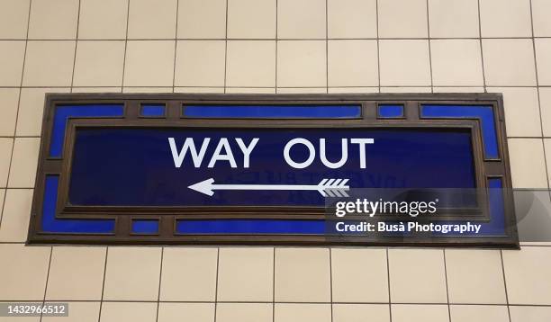 old-fashioned "way out" sign in london tube station - underground sign stock pictures, royalty-free photos & images