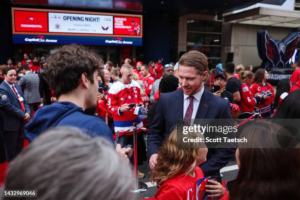 Nicklas Backstrom of the Washington Capitals interacts with fans outside the area before the opening night game against the Boston Bruins at Capital...