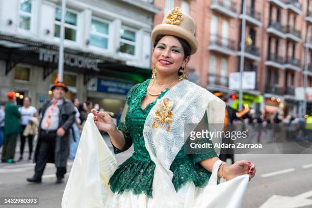 Woman in traditional South American dress dances during the demonstration against Hispanic Day on October 12, 2022 in Madrid, Spain. Spain's National...