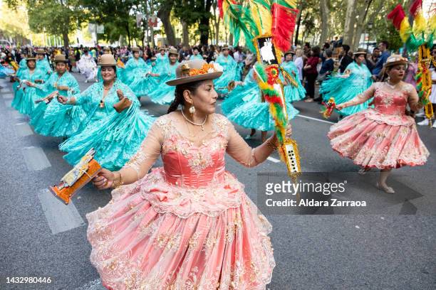 Women in traditional South American dress dance during a demonstration against Hispanic Day on October 12, 2022 in Madrid, Spain. Spain's National...
