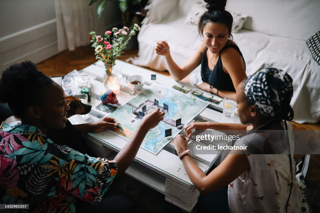 Group of friends playing a boardgame at home