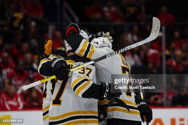 Patrice Bergeron of the Boston Bruins celebrates with teammates after scoring a goal against the Washington Capitals during the first period of the...