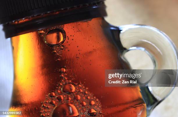 close up of unopened maple syrup in glass bottle with handle - maple syrup stock pictures, royalty-free photos & images