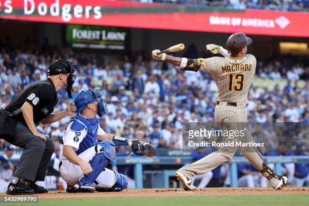 Manny Machado of the San Diego Padres hits a solo home run in the first inning during game two of the National League Division Series against the Los...