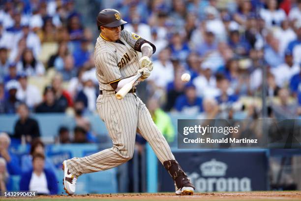 Manny Machado of the San Diego Padres hits a solo home run in the first inning during game two of the National League Division Series against the Los...