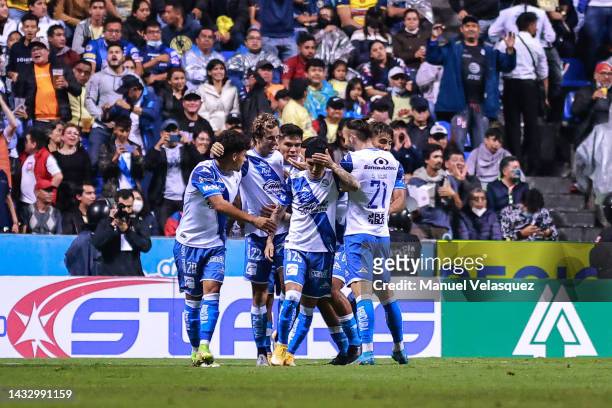 Jordi Cortizo of Puebla celebrates with his teammates after scoring his team's first goal during the quarterfinals first leg match between Puebla and...