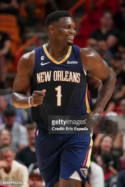 Zion Williamson of the New Orleans Pelicans smiles as he runs back upcourt during the first half of the game against the Miami Heat at FTX Arena on...
