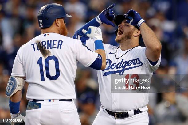 Max Muncy of the Los Angeles Dodgers celebrates his solo home run with Justin Turner in the second inning in game two of the National League Division...