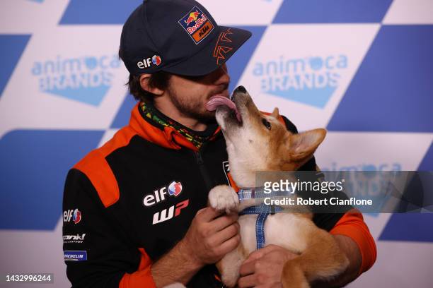 Remy Gardner of Australia and Tech3 KTM Factory Racing, poses with a dingo pup during previews ahead of the MotoGP of Australia at Phillip Island...