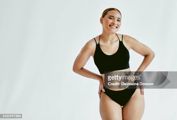 slim body, figure and fit woman standing against studio background for health, wellness and weightloss process. brazilian female model with thin shape and smile while posing in underwear for diet - voluptuous body stock pictures, royalty-free photos & images