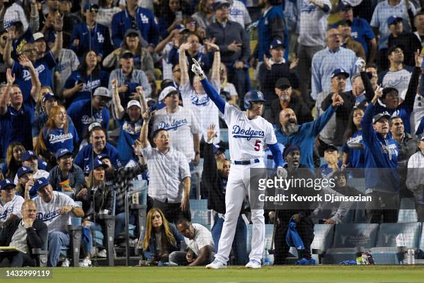 Freddie Freeman of the Los Angeles Dodgers celebrates a home run by Trea Turner in the third inning in game two of the National League Division...
